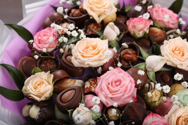 Beautiful food bouquet of sweets and flowers closeup