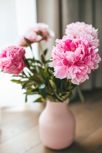 Beautiful fresh bouquet of peonies in a pink vase