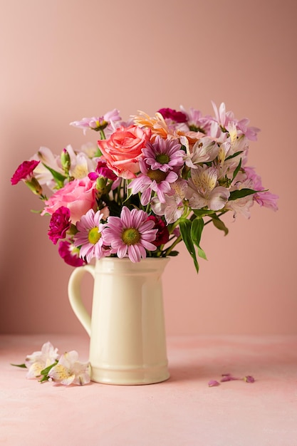 Beautiful fresh flowers Pink bouquet of flowers in vase on pink background