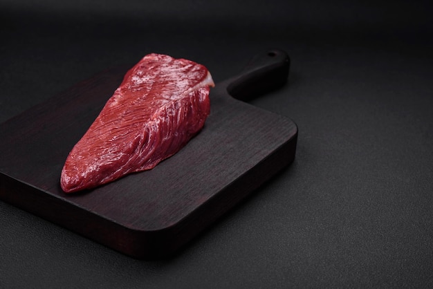 Beautiful fresh piece of raw beef on a wooden cutting board