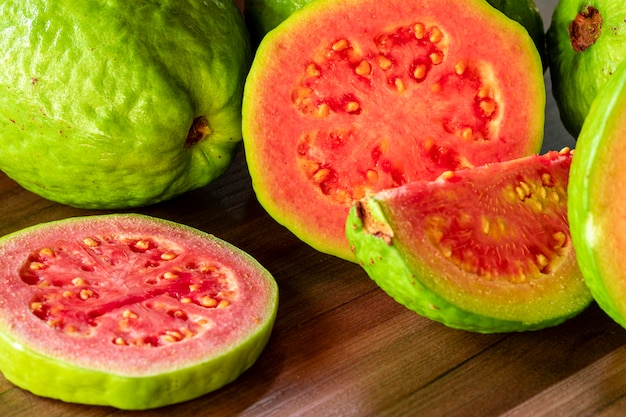 Beautiful fresh red guava, autumn fruit on wooden rustic table