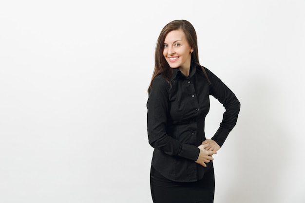 Beautiful fun happy caucasian young smiling brown-hair business woman in black classic shirt and skirt looking camera isolated on white wall