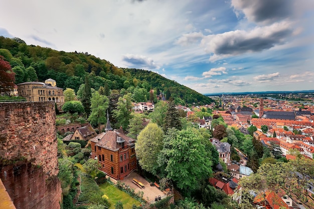 Beautiful Germany. Aerial view over Heidelberg town in Spring. City center with tiled roofs, river Neckar and hills with forest.