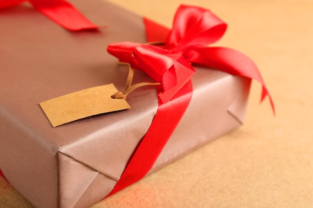 Beautiful gift with bow on wooden background