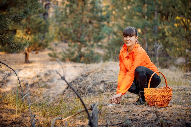 Beautiful girl in the autumn forest to gather mushrooms Stay in the fresh air