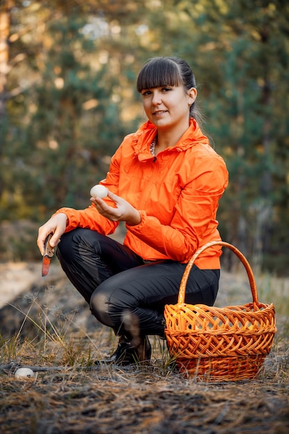 Beautiful girl in the autumn forest to gather mushrooms Stay in the fresh air