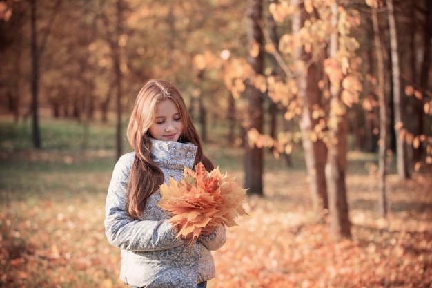 Beautiful girl in autumn park