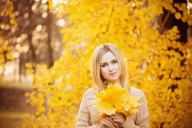 Beautiful girl in autumn park