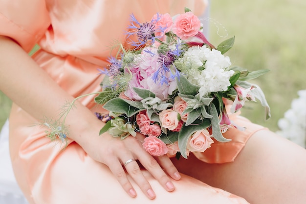 beautiful girl in a bathrobe with a bouquet of flowers