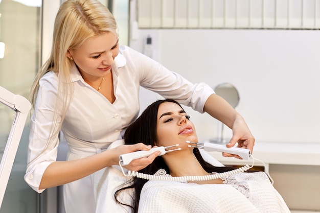 Beautiful girl in a beauty salon at cosmetology procedures