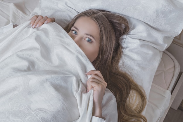 beautiful girl on the bed getting ready for bed