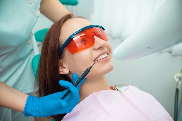 Beautiful girl in a chair at the dentist. Medical office. Dental examination. Dental treatment. Doctor and patient