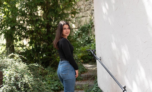 beautiful girl climbs the stairs looking back smiling