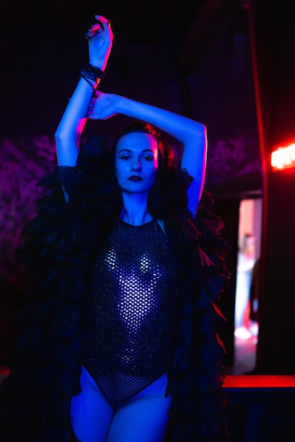 Beautiful girl dancer posing on the stage of a nightclub Party concept