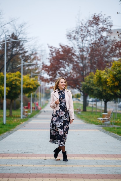 Beautiful girl in a dress on a city alley