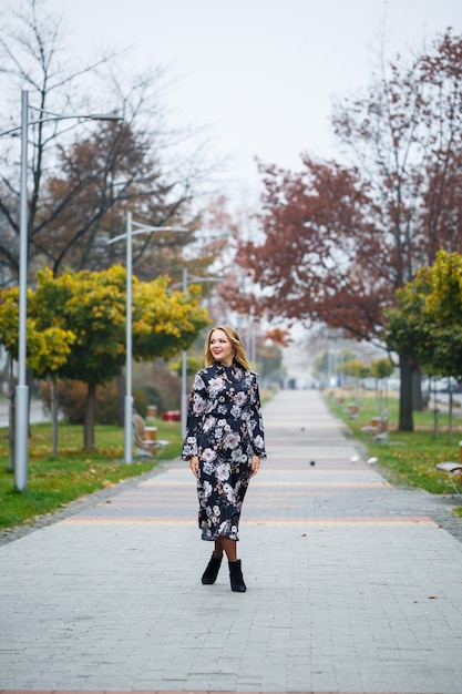 Beautiful girl in a dress on a city alley