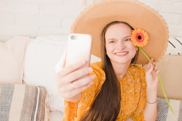 Beautiful girl in a dress makes a selfie in the summer