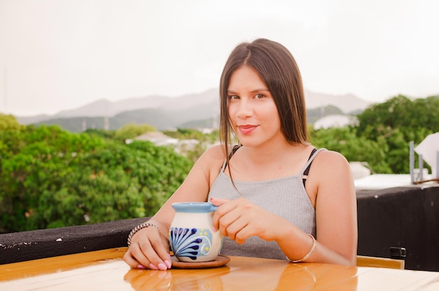 beautiful girl drinking in the table