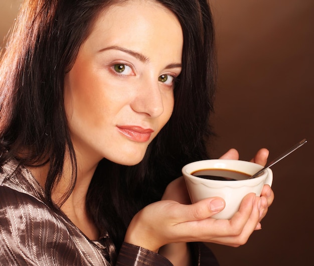 Beautiful girl drinking tea or coffee