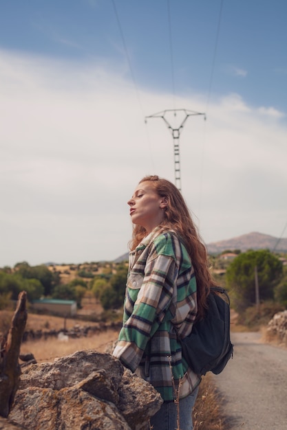 A beautiful girl enjoys of environment with her eyes closed