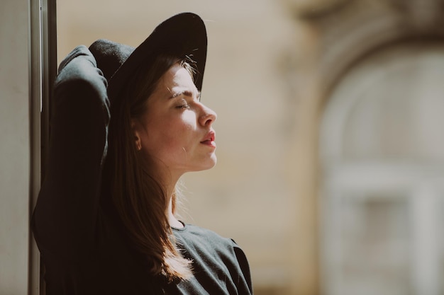 Beautiful girl face closeup outside portrait of young woman in fashion hat summer romantic casual wo