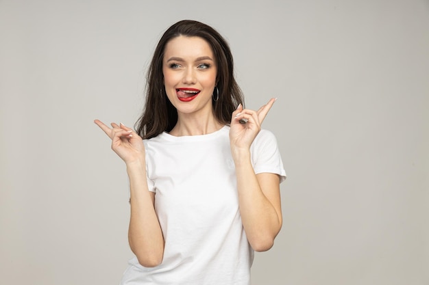 A beautiful girl in a good mood on a light background