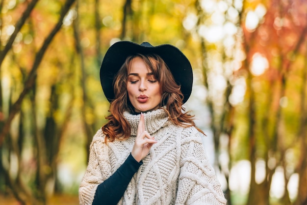 Beautiful girl in a hat with curly hair