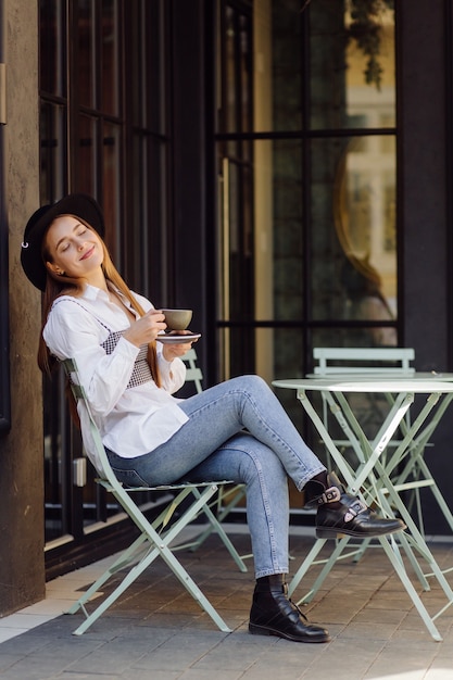 Beautiful girl having coffee at cafe