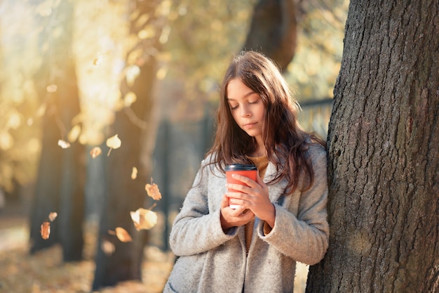 Beautiful girl holding a cup of coffee in her hands