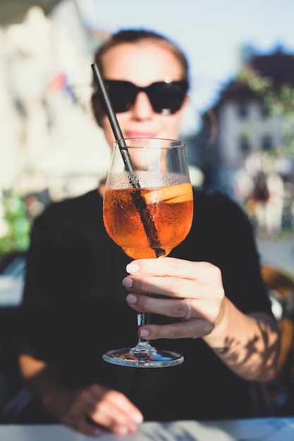 Beautiful girl holding a glass with a cocktail