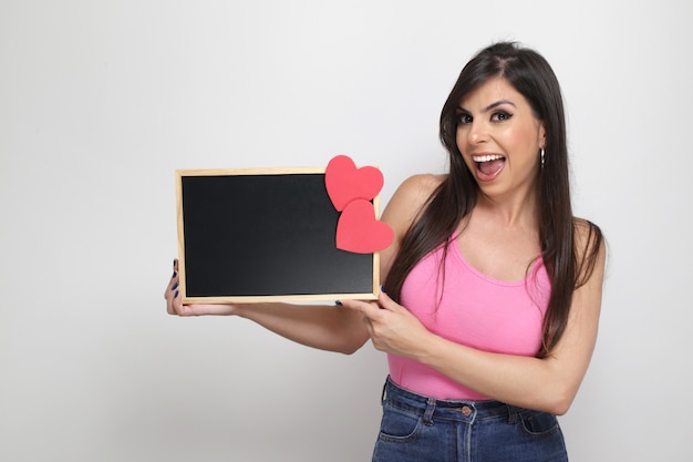 Beautiful girl holding valentine's gift on white background