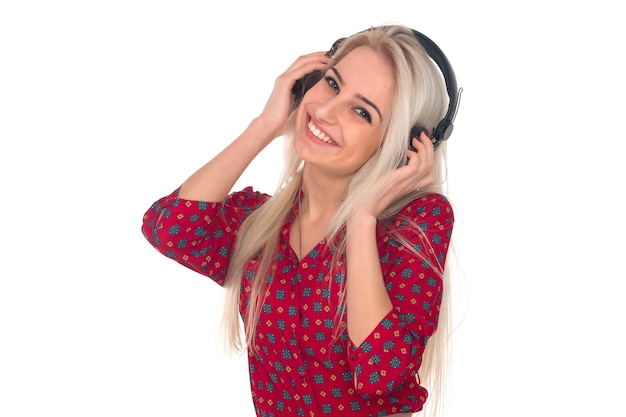 Beautiful girl listens to music on headphones