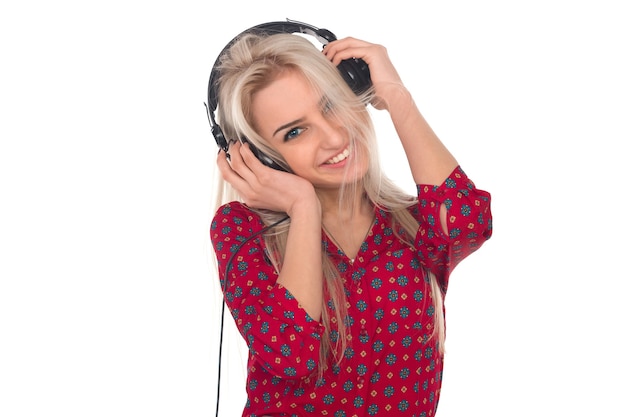 Beautiful girl listens to music on headphones