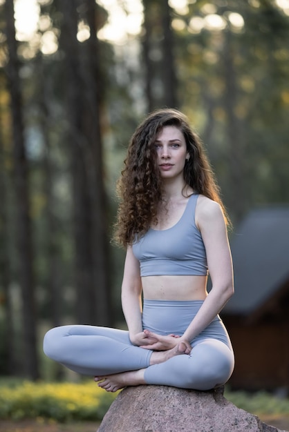 Beautiful girl meditating yoga meditation practice in nature