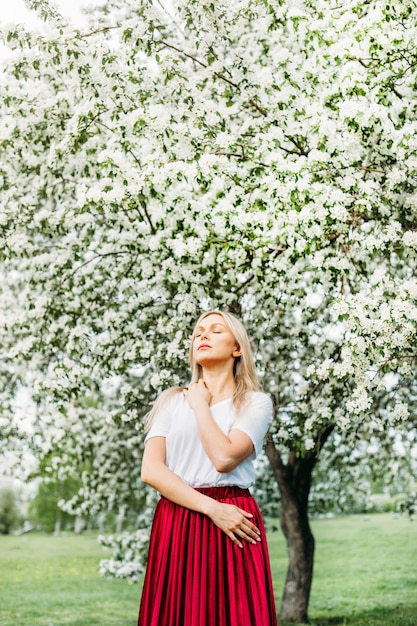 Beautiful girl  near flowering trees