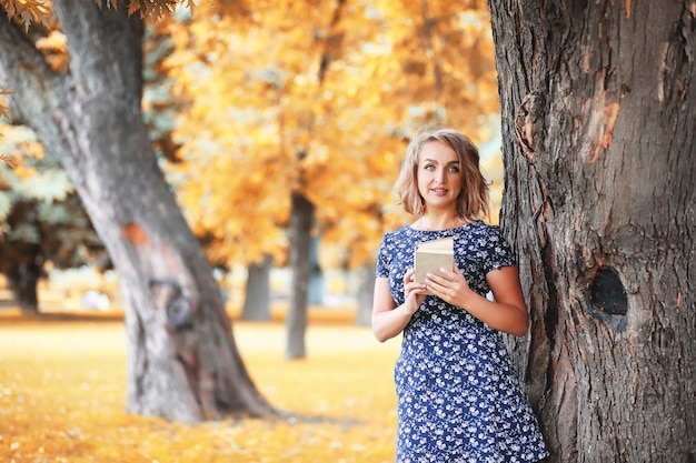 Beautiful girl in the park on a autumn sunny day walk