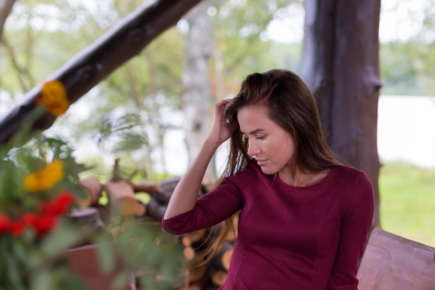 Beautiful girl in red dress in the greenhouse