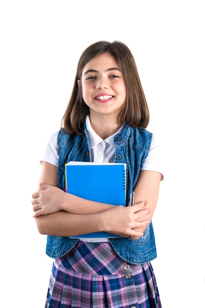 Beautiful girl in school uniform with a notebook in her hand on a white background.