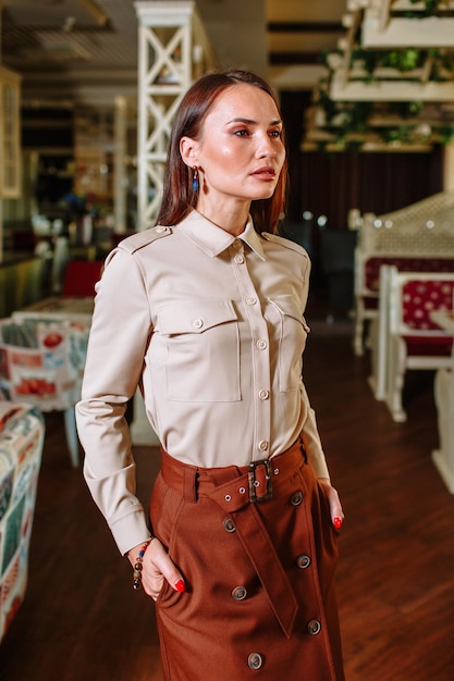 A beautiful girl showing fashionable clothes against the backdrop of the restaurant scenery Clothes for the showroom