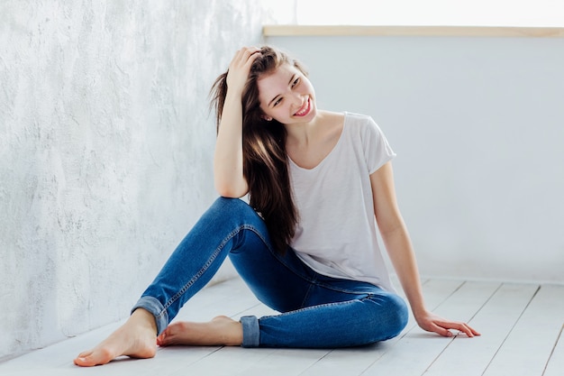 Beautiful girl sitting on the floor