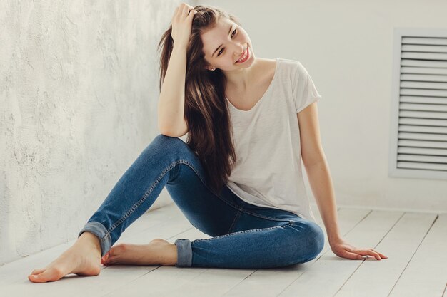 Beautiful girl sitting on the floor