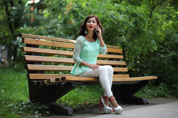 Beautiful girl in a spring leaf park in the afternoon