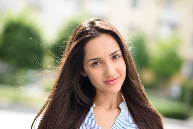 Beautiful girl on the street smiling.