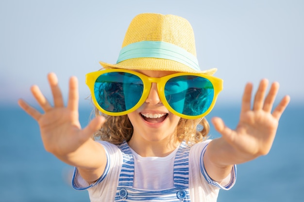 Beautiful girl on summer vacation Happy teenager having fun on the beach