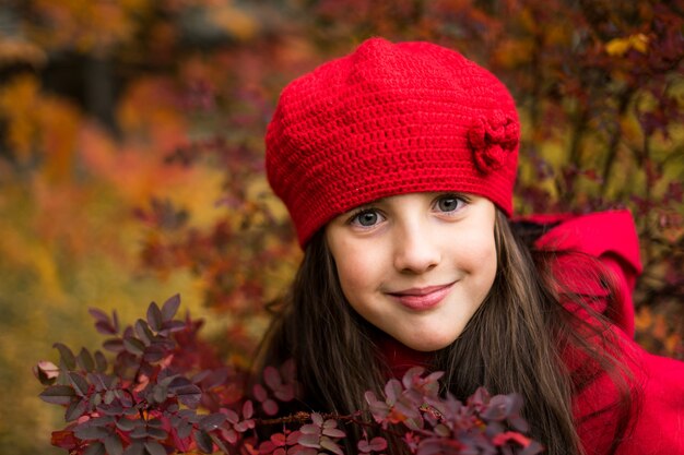 Beautiful girl in sunny autumn park Child playing in park at autumn Autumn mood High quality photo