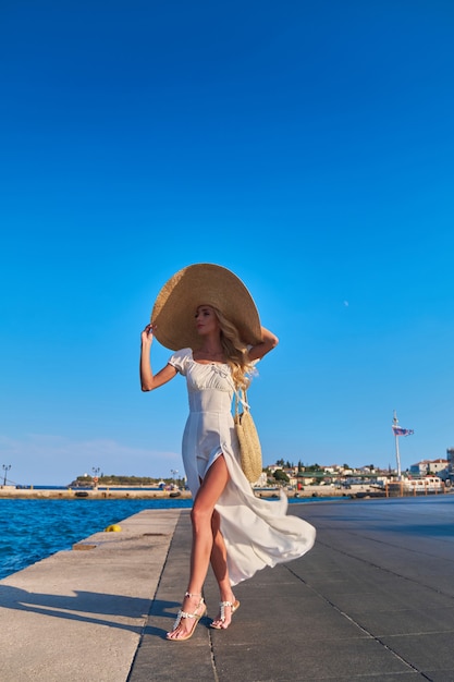 Beautiful girl tourist walking at spetses marina seaport greece