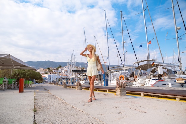 Beautiful girl tourist walking in the streets of poros greece