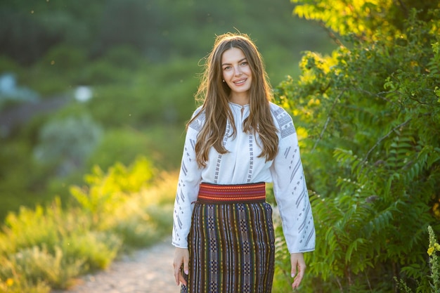 Beautiful girl in traditional Romanian folk costume with embroidery Woman traditional blouse