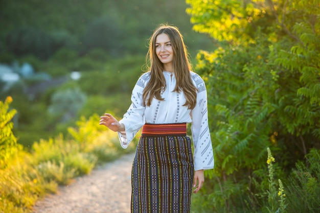 Beautiful girl in traditional Romanian folk costume with embroidery Woman traditional blouse