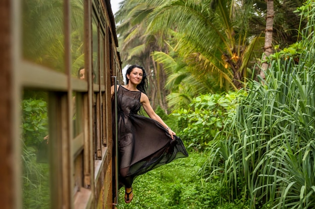 Beautiful girl travels by train in Sri Lanka . Sri Lanka trains.